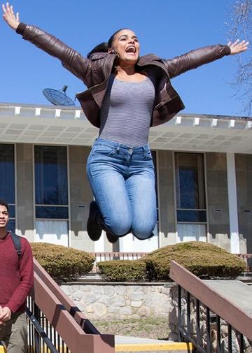 Student excited and jumping in air